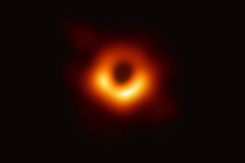 The first image of a black hole, which shows a ring of orange with a center of black.