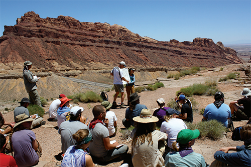 Students listen to a geology lecture in the field