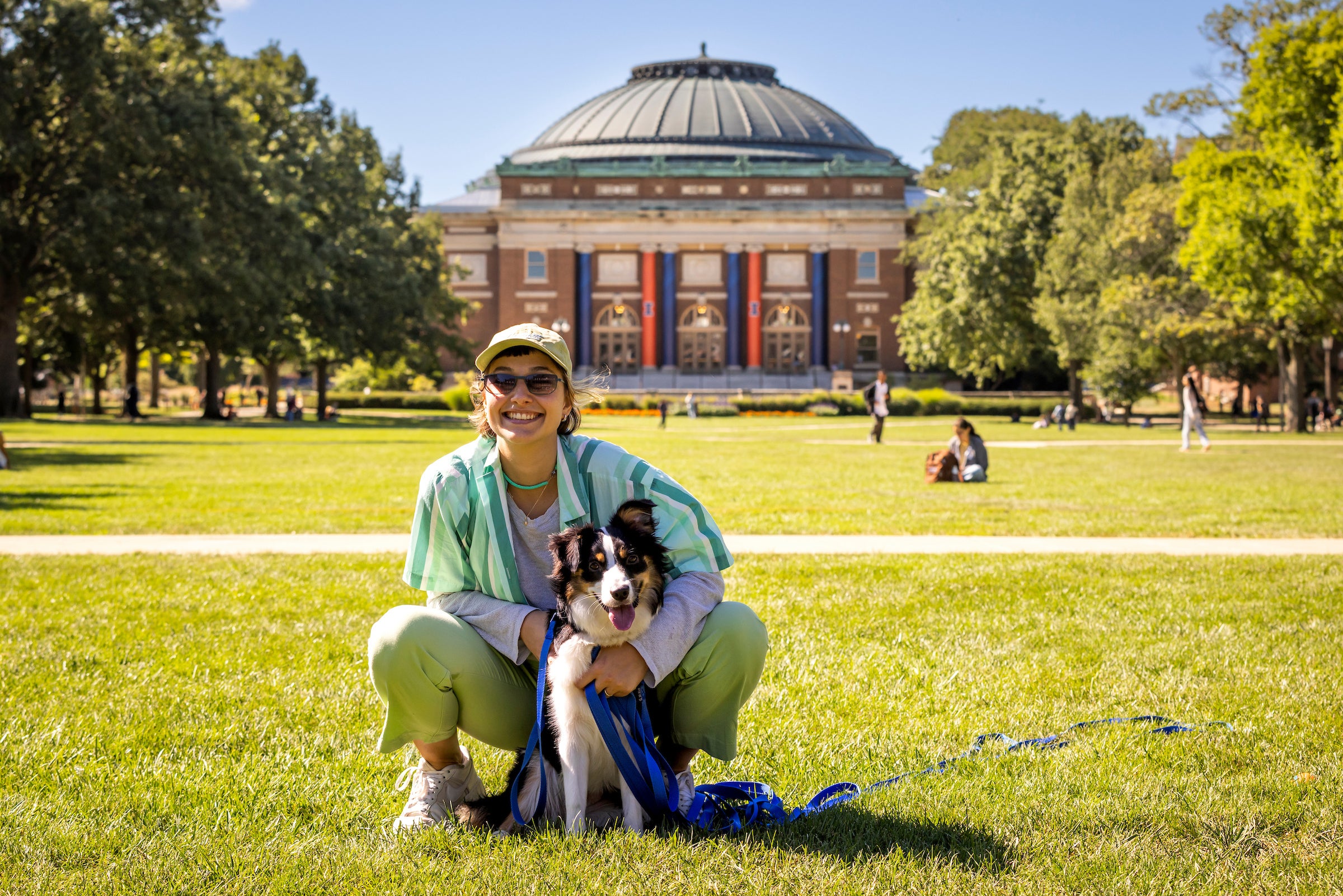 student with dog on main quad