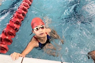 LAS news writing intern Fancy Cheng swimming when she was younger.
