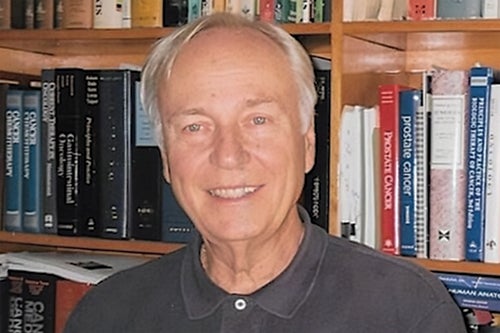 Bob Byars in front of bookshelf