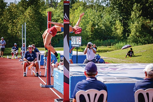 Straus flipping over a high bar