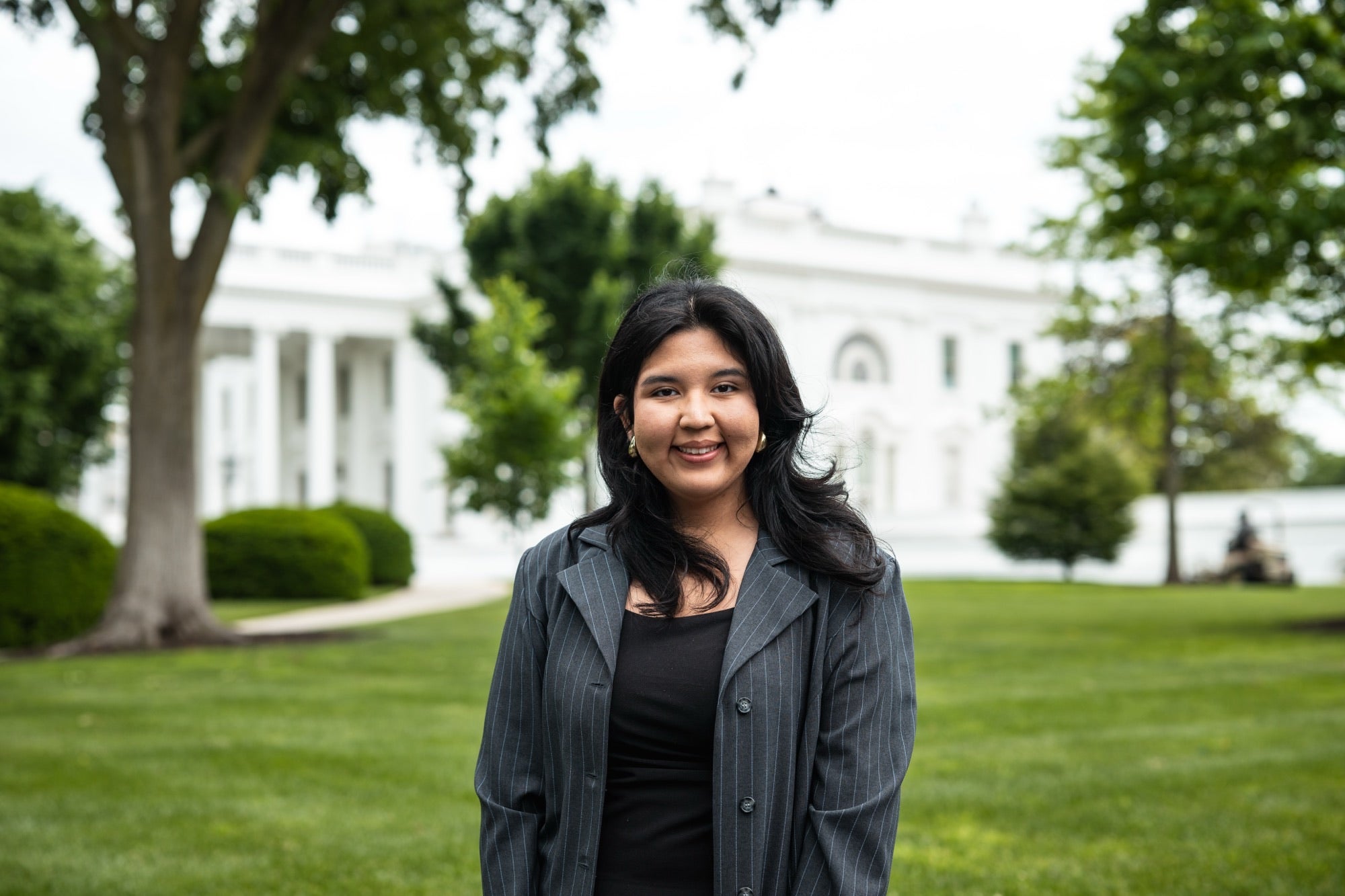 LAS student Abby Estrada-Hernandez standing on the lawn with the White House in the background 