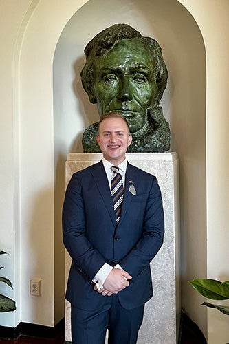 Adham Sahloul stands in front of a bust of Abraham Lincoln