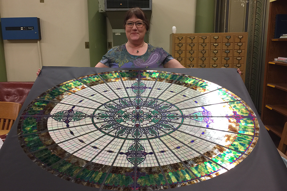 Jane Bergman displays her replica of the glass dome that once overlooked the library in Altgeld Hall.