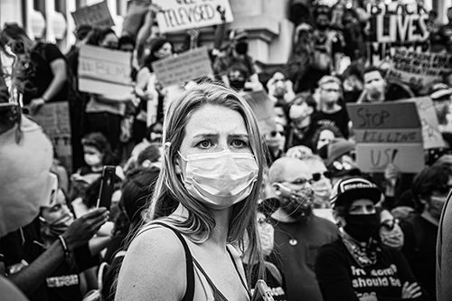 Black and white photo of a woman at a protest