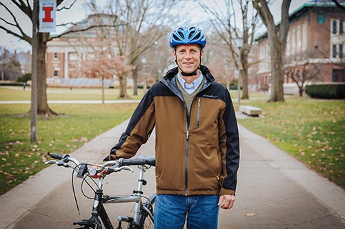 Dave Tewksbury on the Main Quad with bicycle