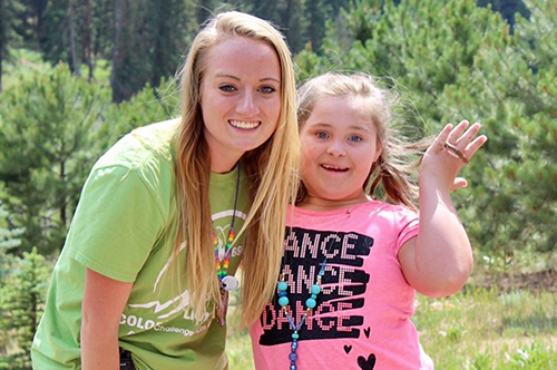 Heather Holmes poses with a camper during her time working work at a Missouri camp for people with special needs