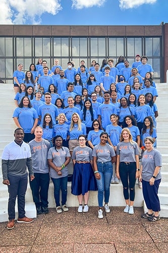 LAS 101 interns pose together on a staircase