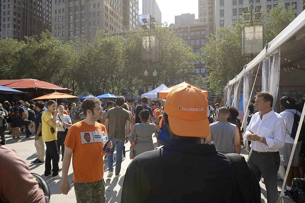 An LAS alumnus walks through the crowd at IlliniFest