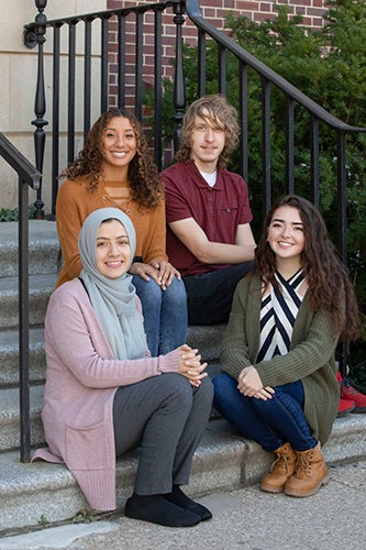 Jason poses with three other students from the Department of History