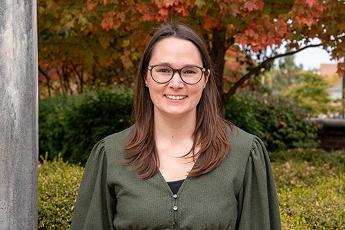 Jen Grove stands outside on a fall day