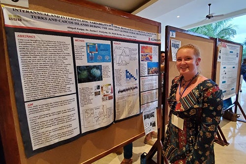 Abby Knipp poses for a photo next to her research project.