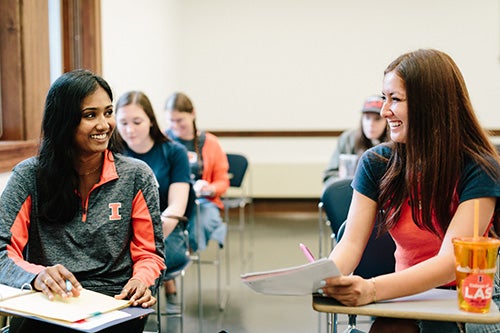 Students smile in a classroom in Lincoln Hall