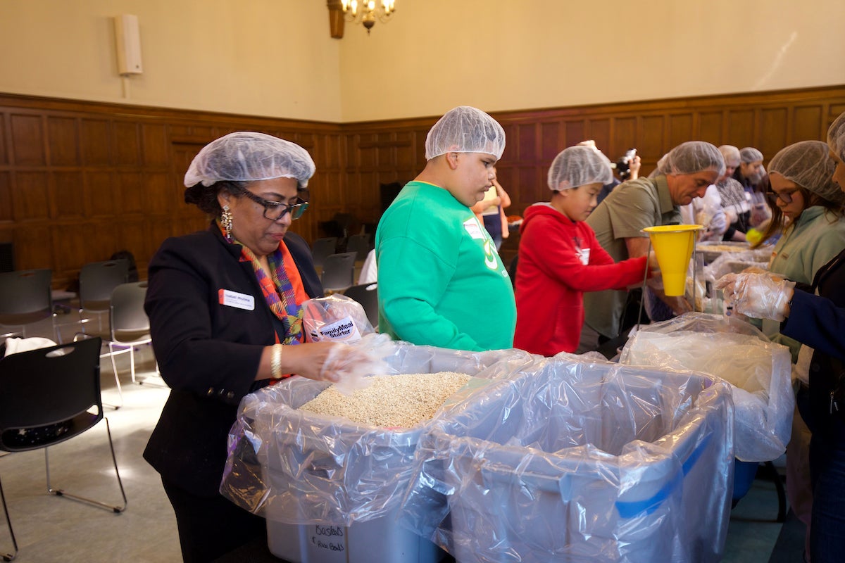 Members of the community putting together food packages at the University YMCA