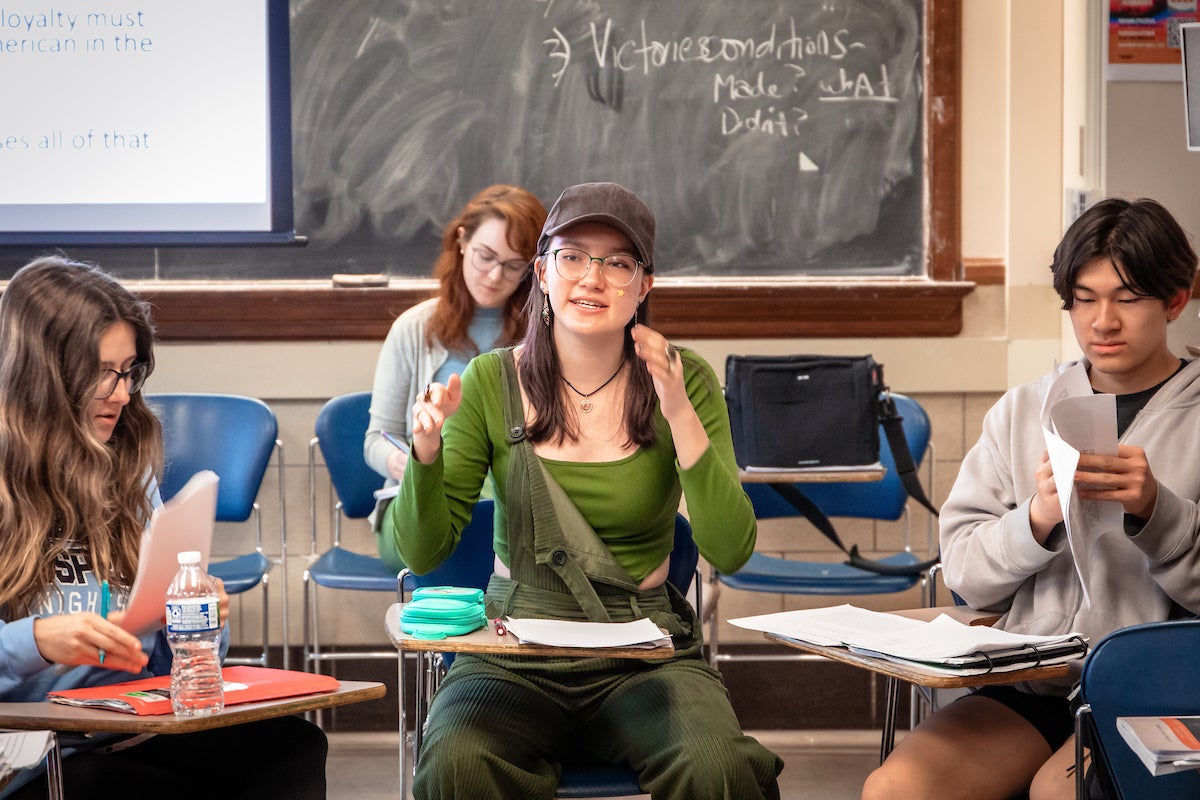 Students in a classroom engaging in a discussion 