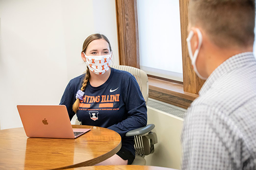 Student in mask with laptop