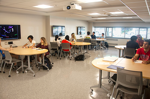 Students at tables in the MCB Learning Center