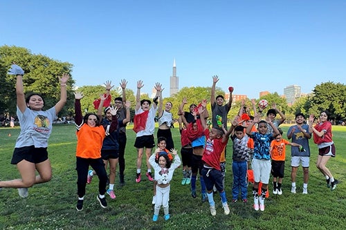 Kids posing for photo on soccer field