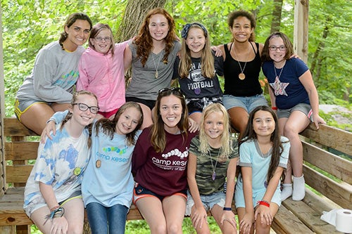 Maggie posts with campers at Camp Kesem