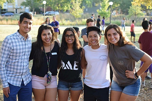 Maggie and a group of friends on campus