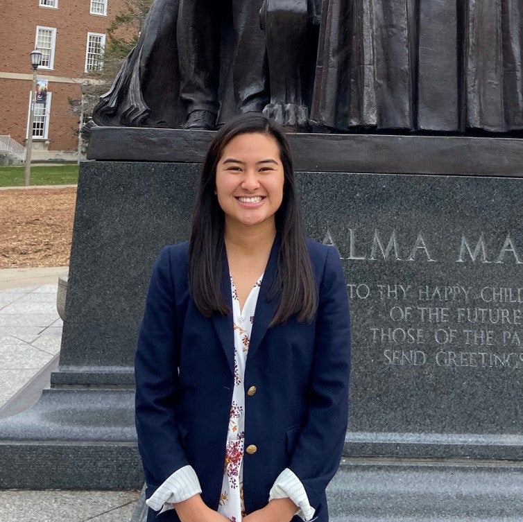 Megan Choi poses for photo in front of Alma Mater.