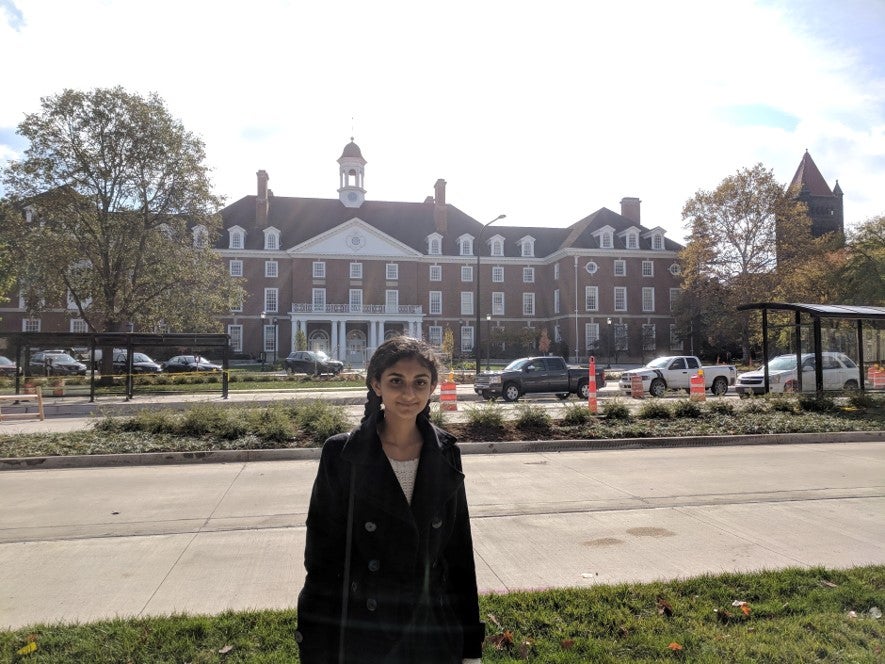 Student poses for a photo on the north side of the student union
