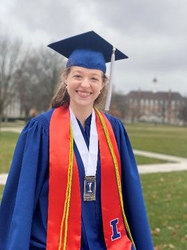 LAS student poses for a graduation photo on the Main Quad