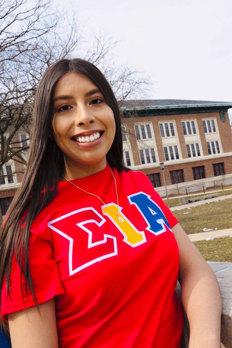 Student poses for photo in front of Lincoln Hall