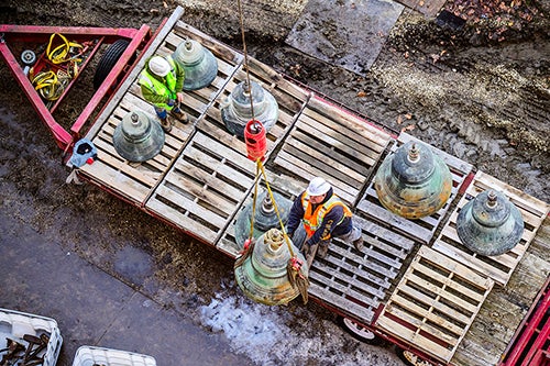 Bells being loaded onto a trailer