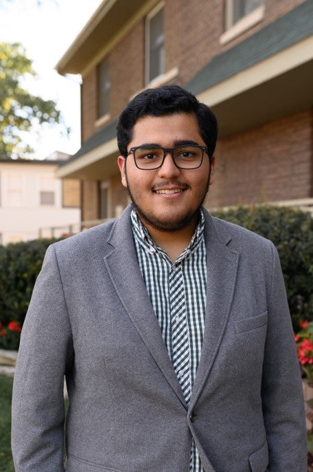 LAS student poses for photo in a gray suit