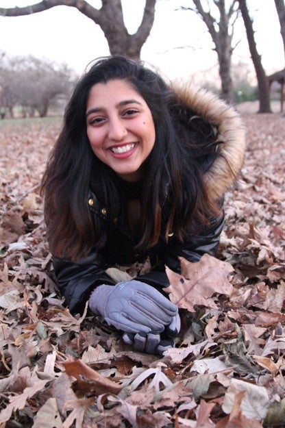 LAS student poses for photo in the fall leaves