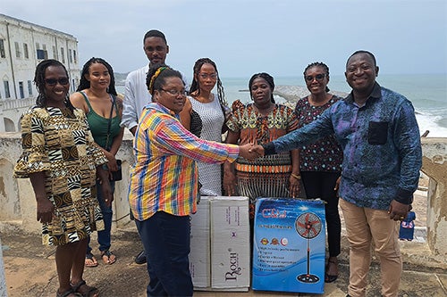 ) Lakisha David (left) with the director of Cape Coast Castle, where David collected saliva samples for her DNA project