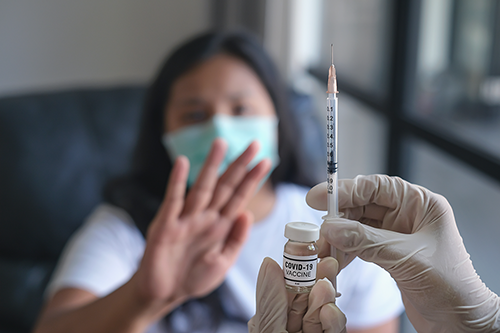 Stock image of woman refusing vaccine