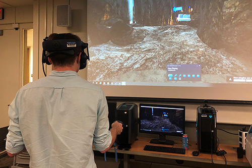 Student enters a cave using virtual reality device