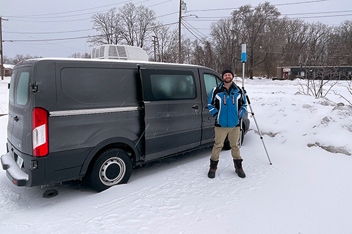 Andrew Janiszeski stands near a radio van.