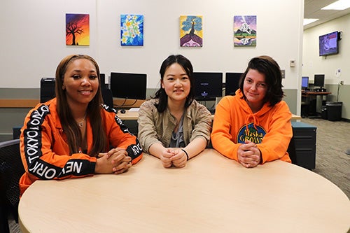 ATLAS interns pose at a table