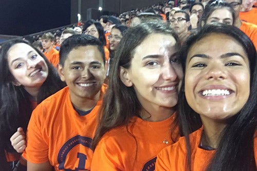 Daria Zelen poses with friends at an Illini football game