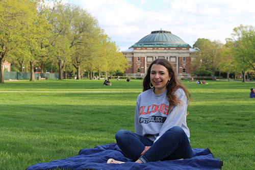 Elena sits on the Main Quad