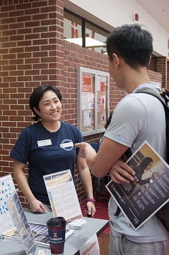 Jenny Kim speaks with a student during the Humanities Expo