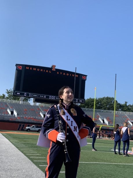 Student in Marching Illini gear at Memorial Stadium