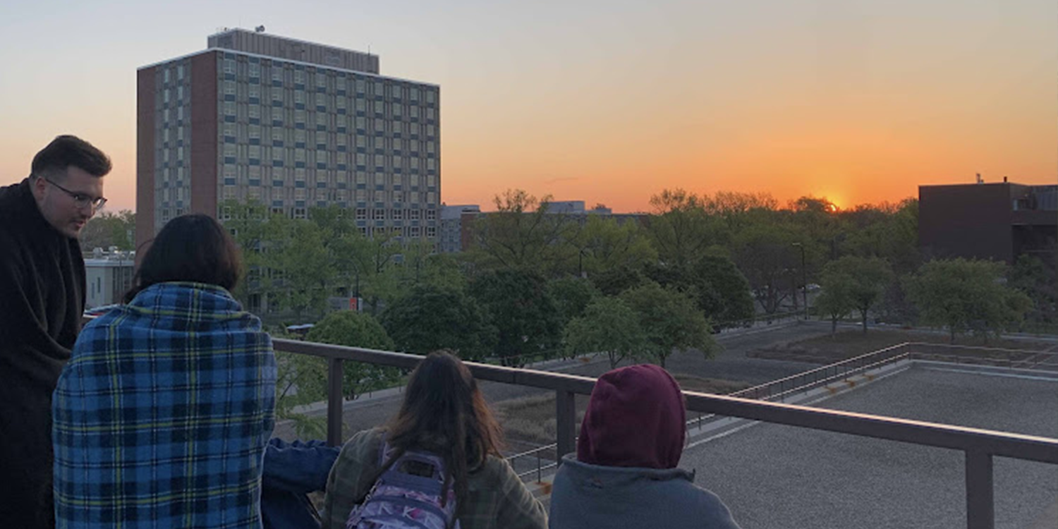 Students enjoy watching the sunrise on Krannert's rooftop.