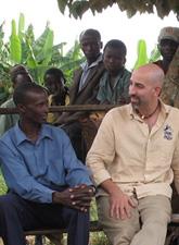 Tom Gillespie (right) attends a Ugandan community meeting. After a decade working with residents and officials in western Uganda, Gillespie enjoys ready access to the region for his research.
