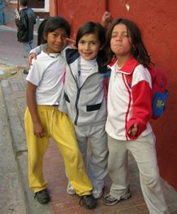 Three children in the colonial neighborhood of La Candelaria, Bogotá, pose for a visitor. (Photo courtesy of Nils Jacobsen)