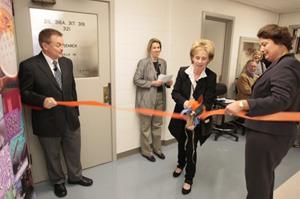 (From left) Stephen Sligar, director of the School of Molecular and Cellular Biology, Mary Wraight, and LAS Dean Ruth Watkins cut the ribbon during a ceremony commemorating an $8 million upgrade at Roger Adams Laboratory. Wraight is the wife of Colin Wraight, former biochemistry department head, who was unable to attend.