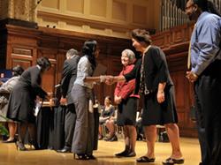 LAS Dean Ruth Watkins shakes hands with one of the Chi Alpha Epsilon inductees.