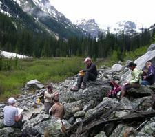 Professor Robert Pahre (standing) converts the side of a hill into a makeshift classroom in Yellowstone National Park. Pahre took 11 students to Yellowstone and Grand Teton last year to study the politics of wildlife and wilderness. (Photo by Carie Steele)