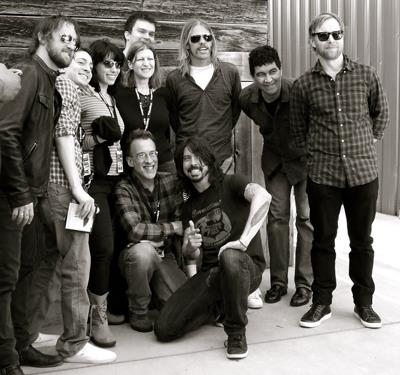 LAS alum Ken Feldman (bottom left) kneels beside the Foo Fighters singer/guitarist Dave Grohl. Feldman and his wife, Gayle Gordon (fourth from the right), won a private concert with the world-famous band.