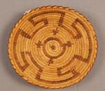 A basket woven by Mary Juan of the Papago tribe constructed of beargrass, yucca, and devil's claw.