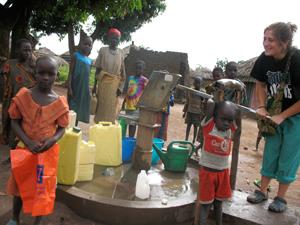 LAS student Jessica Loiacono pumps water for her bath, with her host sister, Joanne, in front.